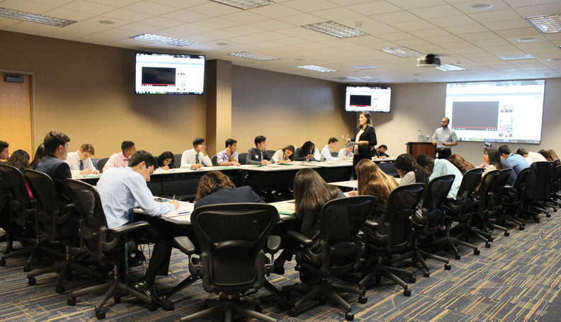 Students take notes at an employability workshop focusing on resume writing at the Atlanta Fed's Miami Branch.