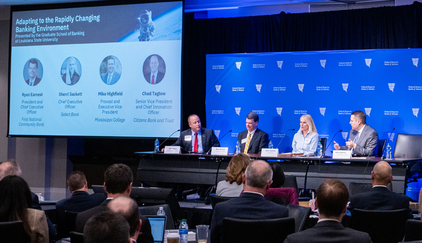 four people sitting on stage having discussions at banking outlook conference