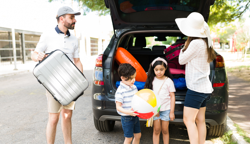 family loading car for vacation