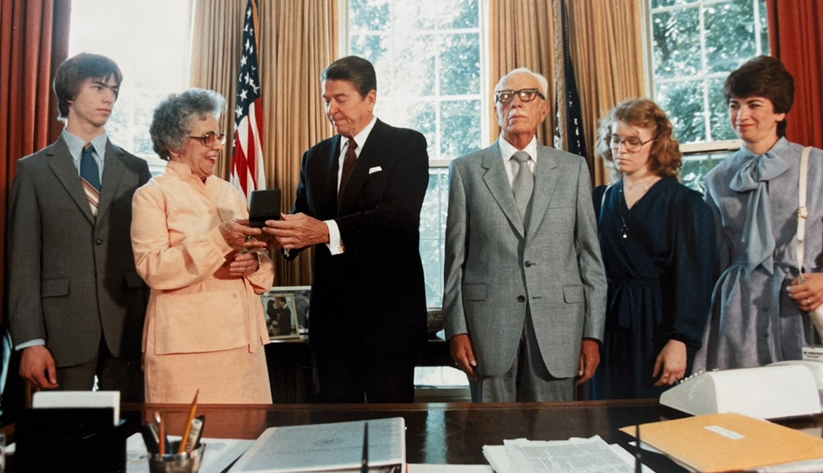 Leslie's grandmother accepts the Coast Guard's Gold Lifesaving Medal from President Reagan, June 1983, on behalf of her son. Left to right: Arland D. Williams III (Trey), Leslie's brother; Virginia Williams, Leslie's grandmother; President Ronald Reagan; Arland D. Williams Sr., Leslie's grandfather; Leslie; Leslie's paternal aunt, Jean Fullmer