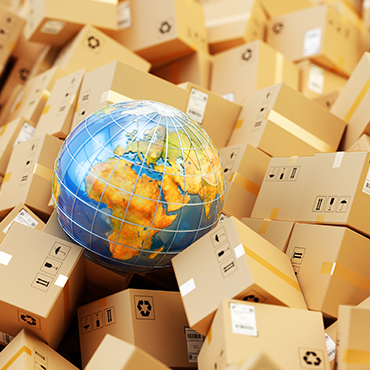 globe on top of pile of cardboard boxes