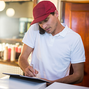 worker taking an order at a restaurant over the phone