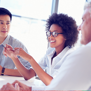 three people in a group discussion