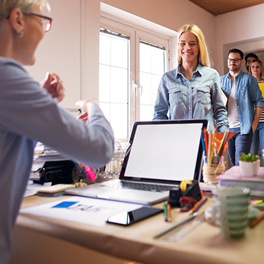 a line of students at the teachers desk