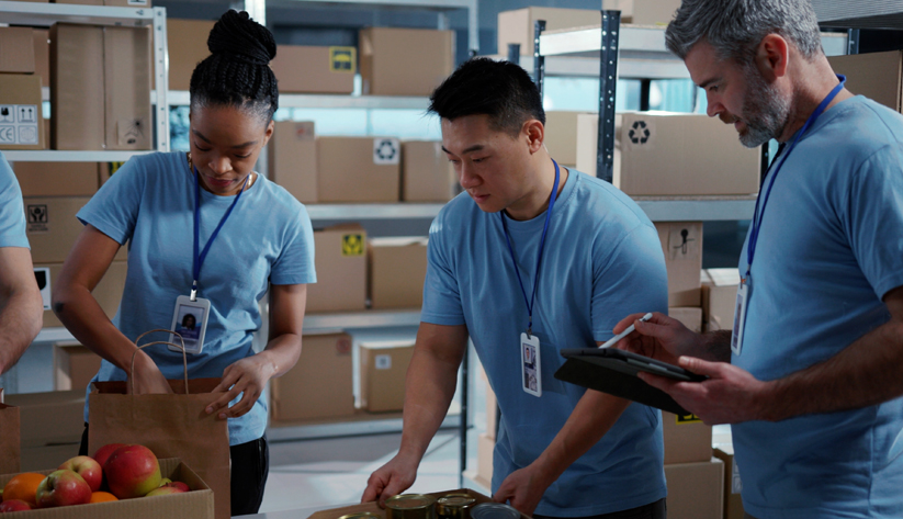 two volunteers packing boxes for charity