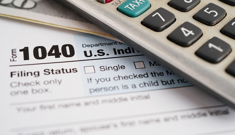 closeup on income tax form money calculator