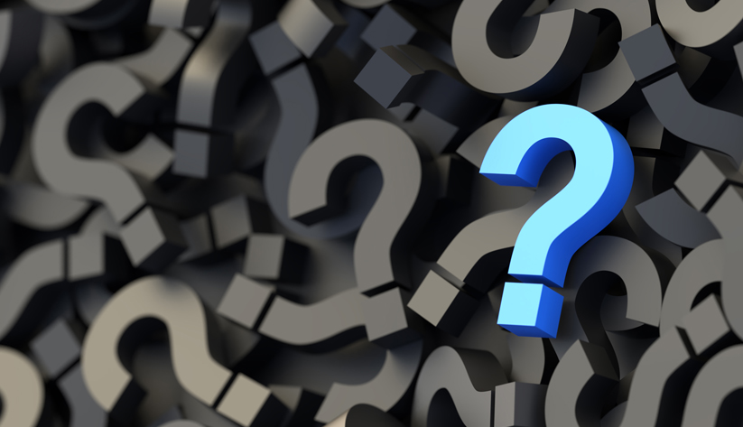 photo illustration of a pile of colored question mark-shaped blocks
