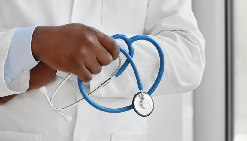 photo of a stethoscope in front of a doctors lab coat