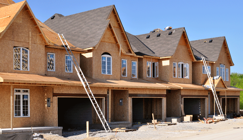 photograph of a row of townhomes under construction