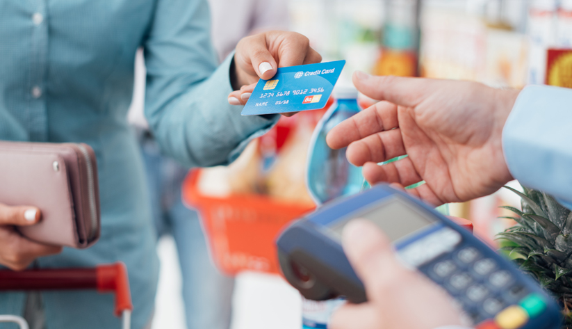 Hands exchanging a credit card for payment