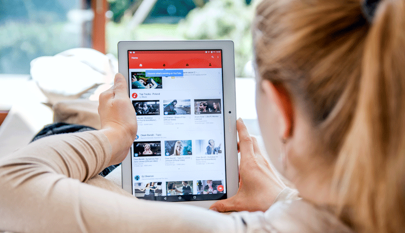Photo of a woman looking at a Youtube playlist