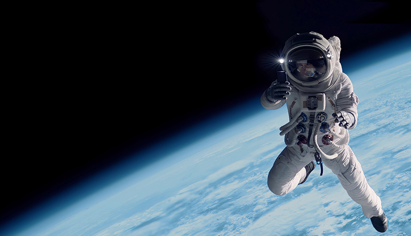 Image of an astronaut floating in space above the Earth.