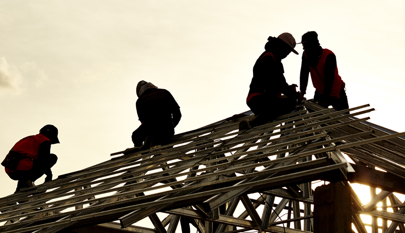 people working on metal frame