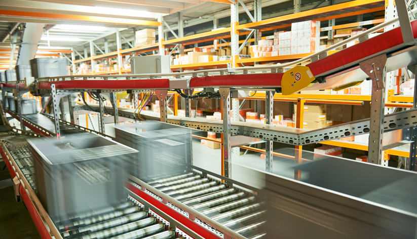 warehouse with crates being transported on roller conveyors