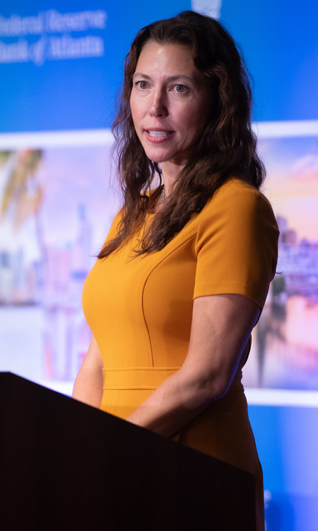 Jessica Washington speaking behind a podium