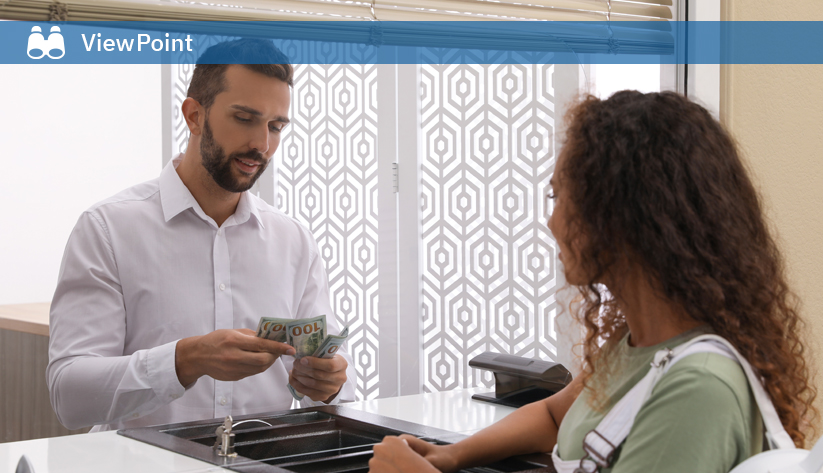 Teller handling cash transaction with customer
