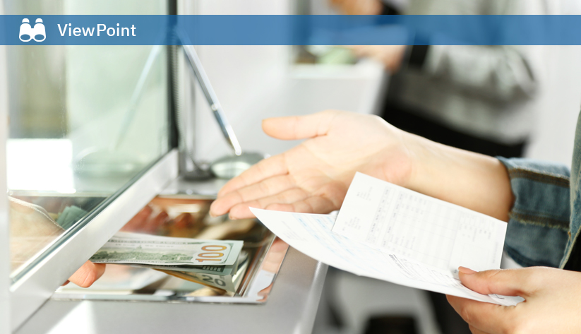 Teller handling cash transaction with customer