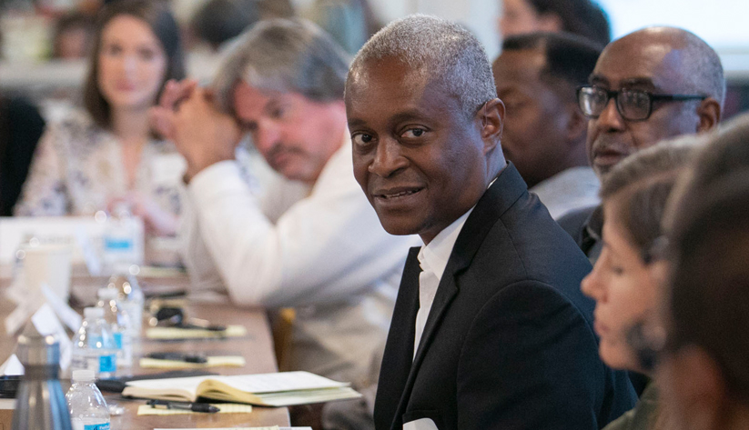 Photo of Raphael Bostic at a table with other people