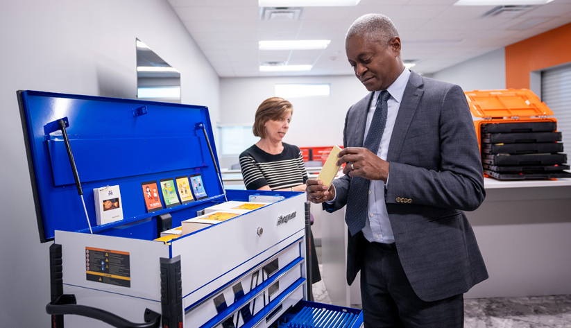 President Raphael Bostic examining object in hands