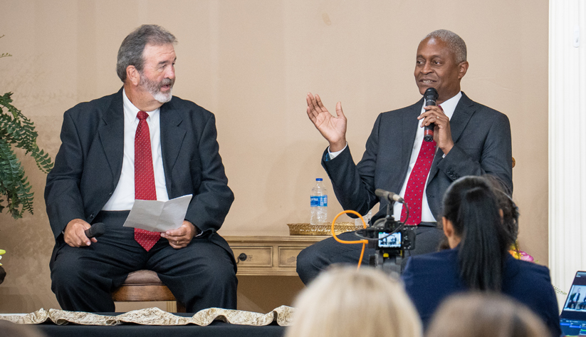 Atlanta Fed president Raphael Bostic (right) in conversation with Timmy James in Red Bay, Alabama