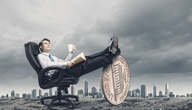 business man with coffee in hand in lounge chair resting feet on large penny