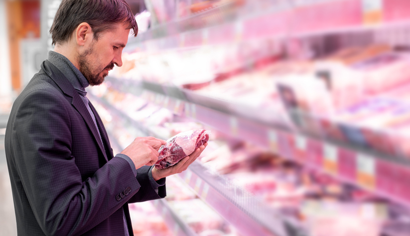 man shopping for meat at grocery store