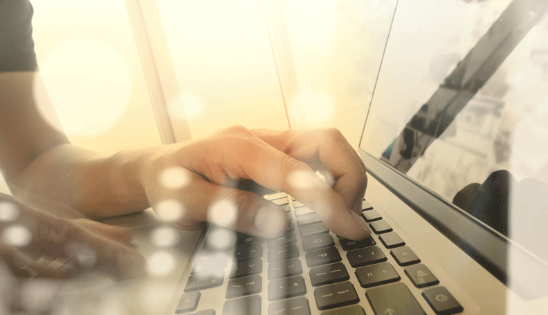 one hand typing on laptop keyboard