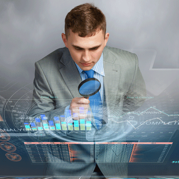 person with magnifying glass over transparent surface with charts