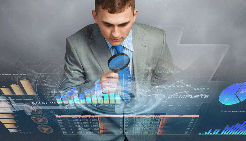 person with magnifying glass over transparent surface with charts