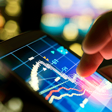 person touching tablet screen with line chart on it