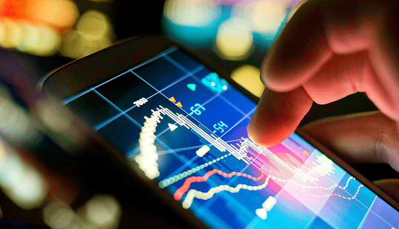 person touching tablet screen with line chart on it