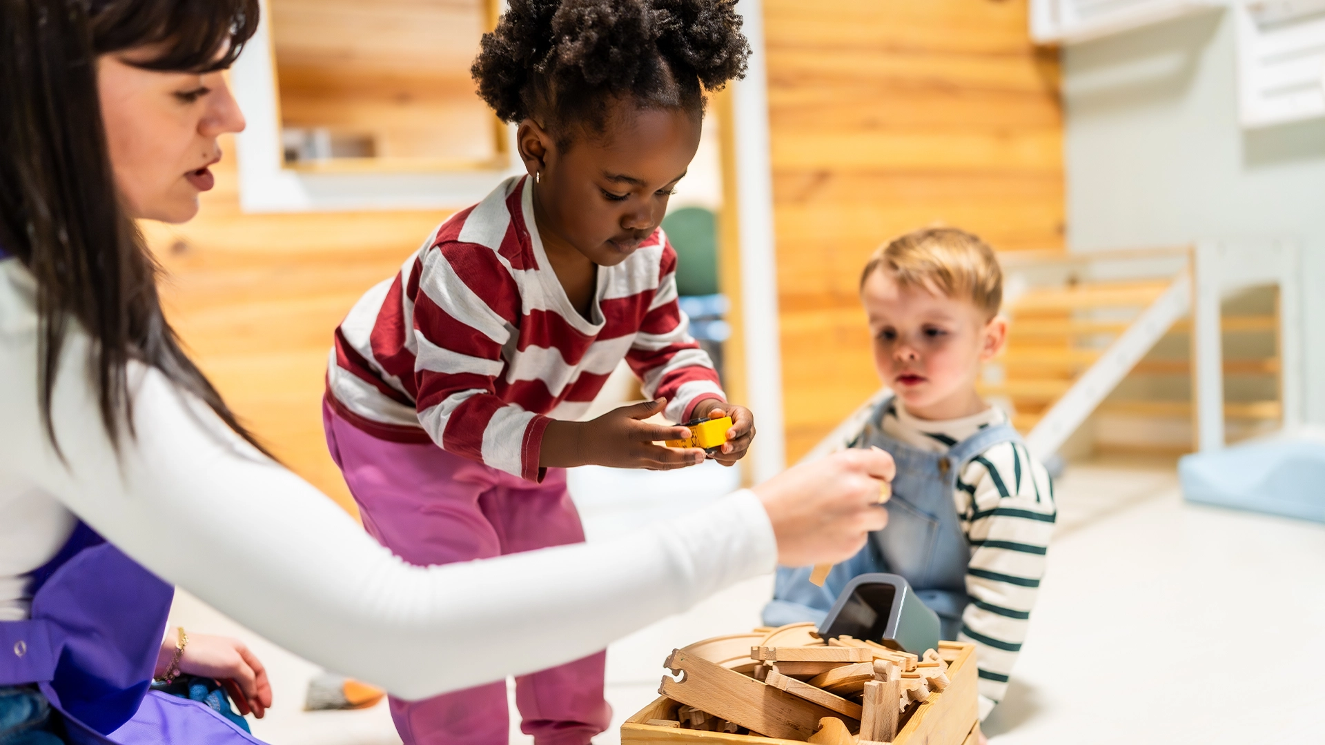 teacher helping children at daycare