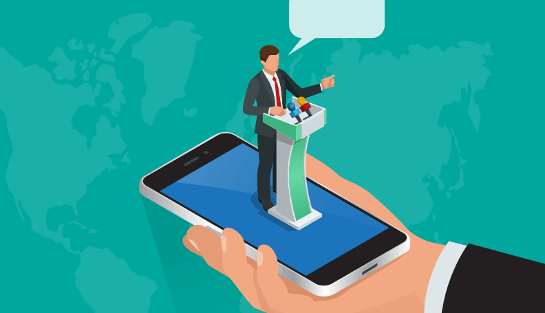 mobile phone with person in business attire standing on screen speaking at podium