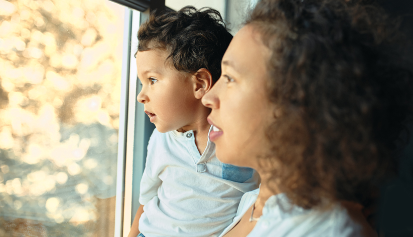 mom and child looking out the window