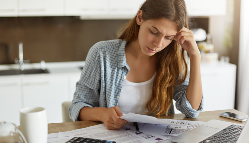 stressed woman paying bills
