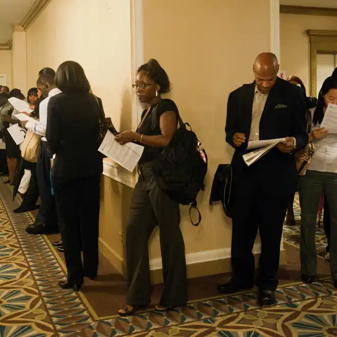 people holding resumes lining up to apply for jobs