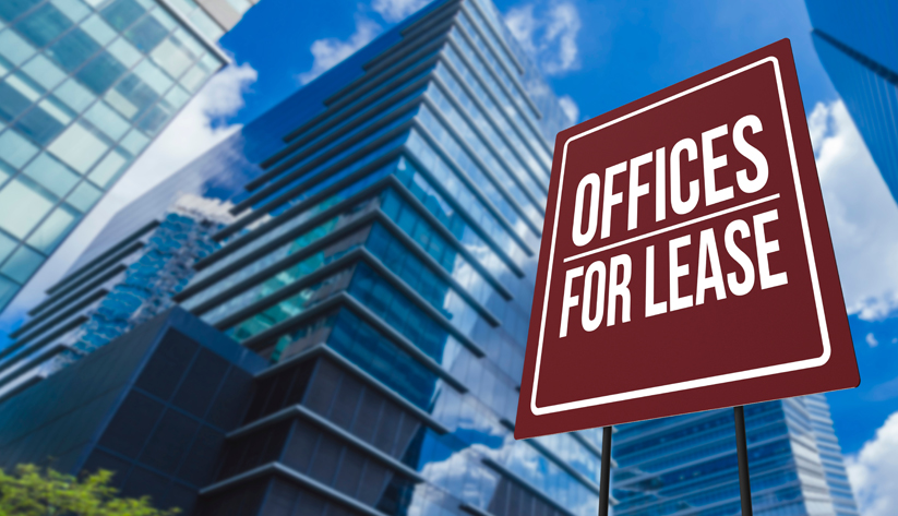 offices for lease sign in front of a highrise building