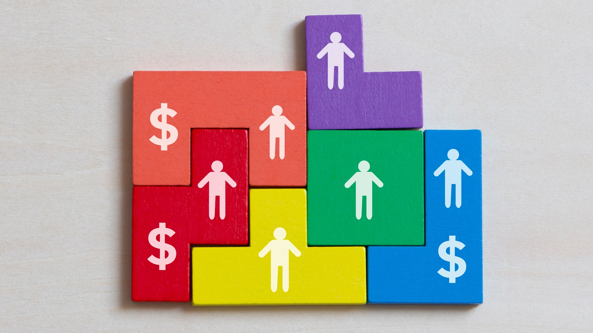 illustration of interlocking colorful building blocks with shapes of people and dollar signs