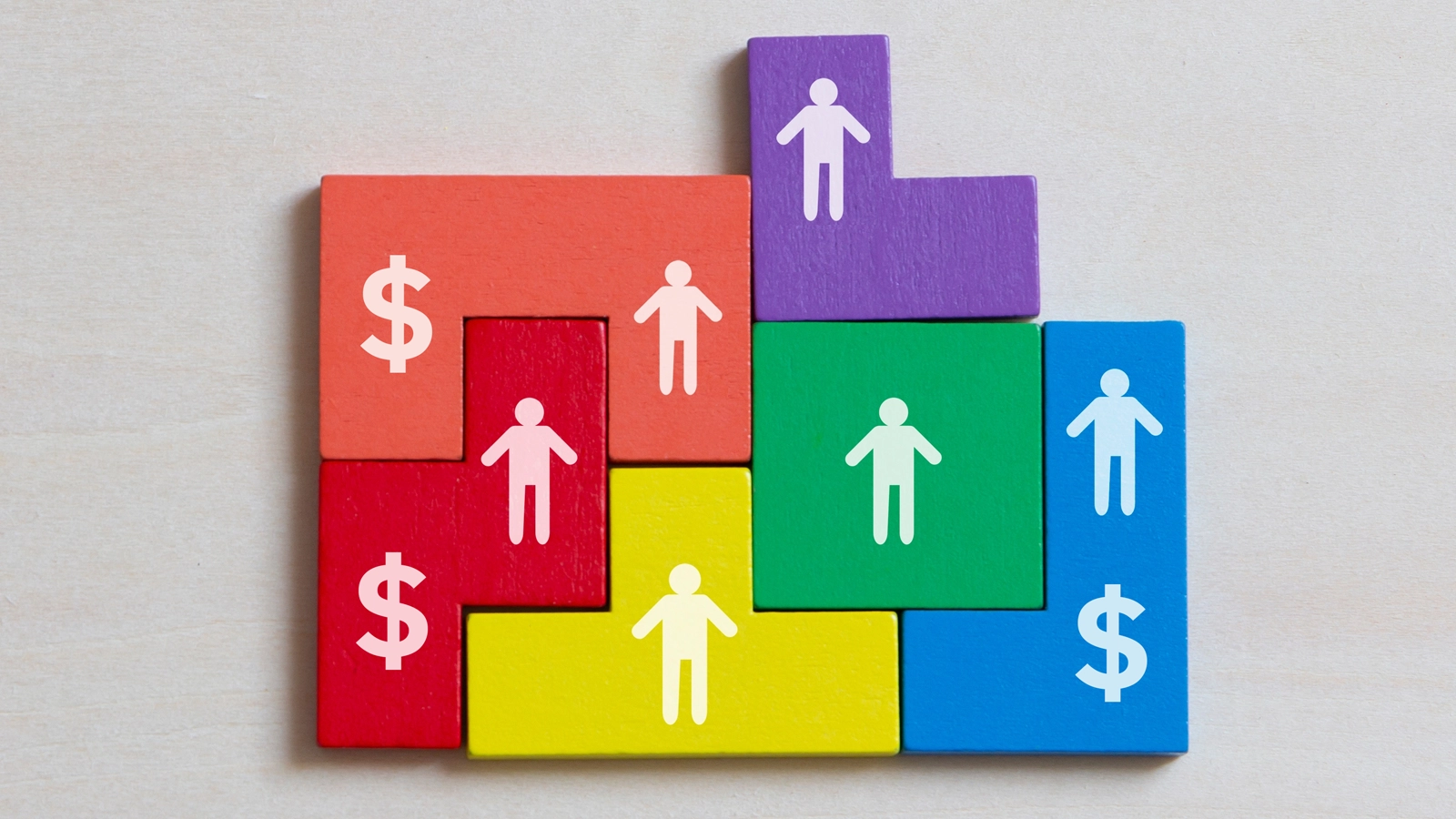 illustration of interlocking colorful building blocks with shapes of people and dollar signs