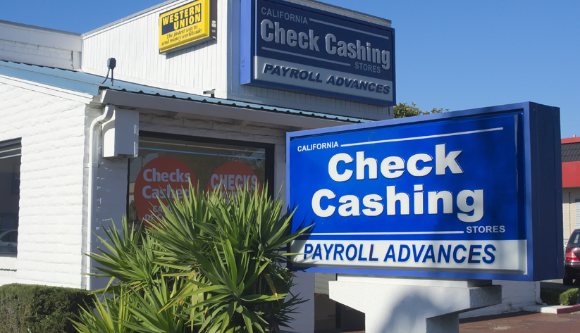 two blue and white store signs for check cashing