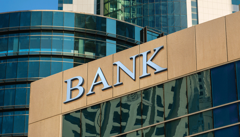 reflective building with the word bank on the top of the building