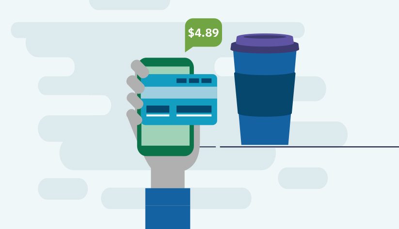 payment card pressed against phone screen next to coffee mug
