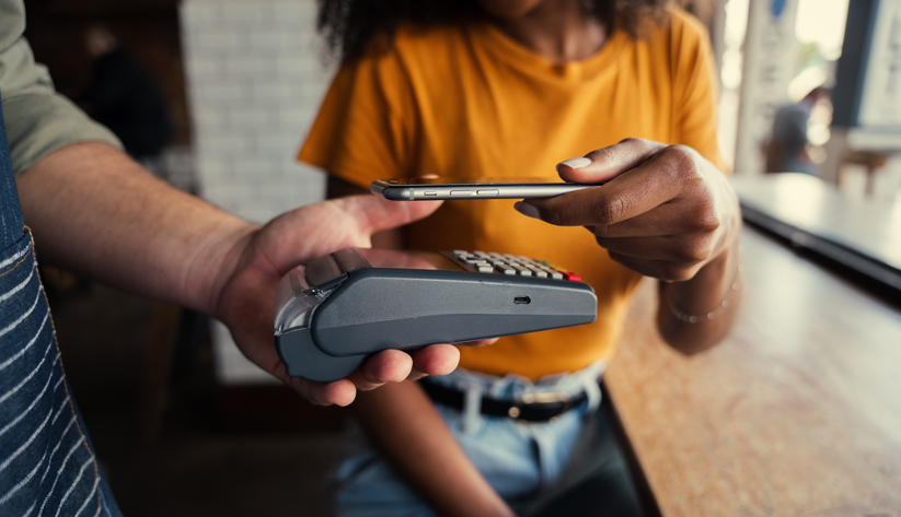 casual handing of payment card to another person holding portable card reader