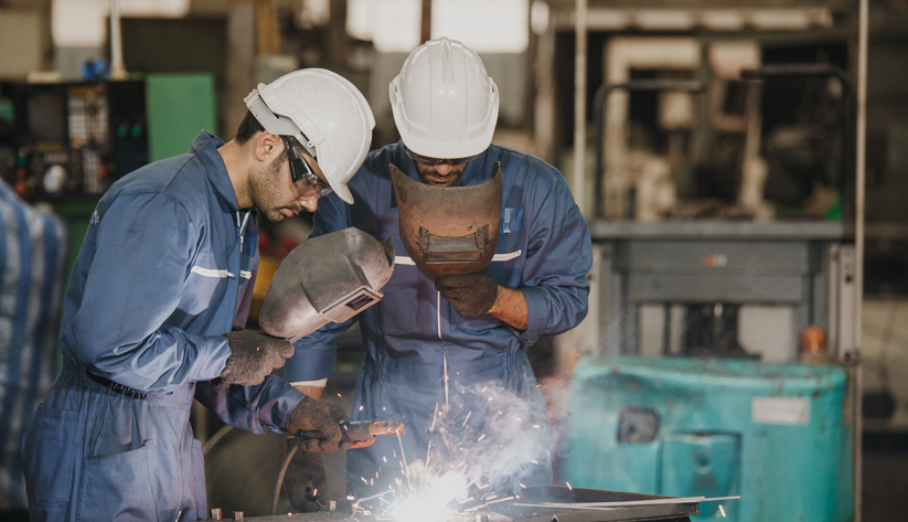 two construction workers welding