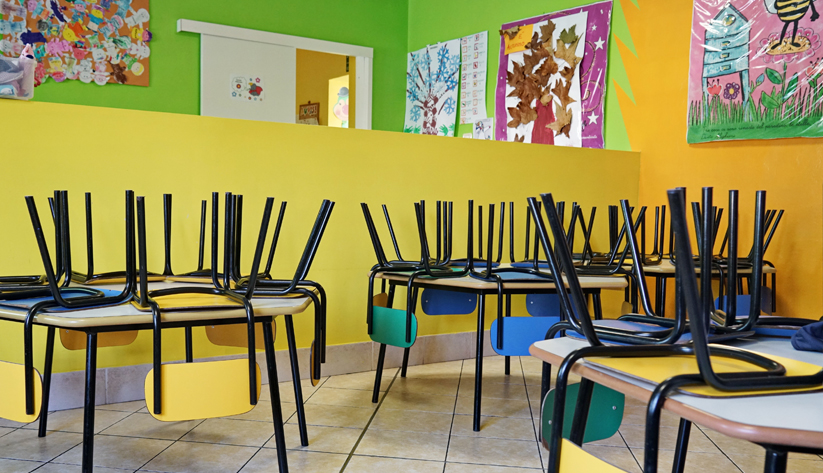a room closed showing tables with chairs on top of them