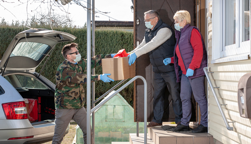 handing off packages with gloves and masks