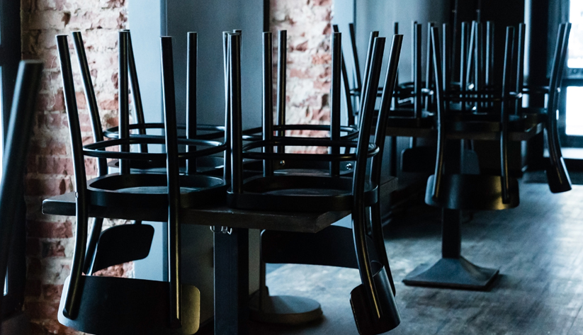 chairs up on a table at a closed business