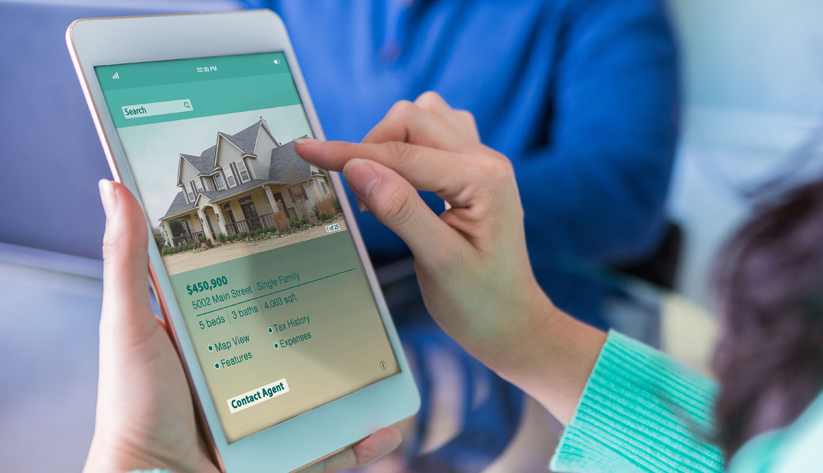 lady holding tablet with house on it