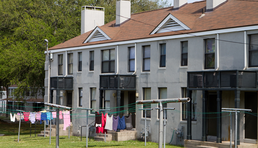 large house with clothes hanging to dry in front yard