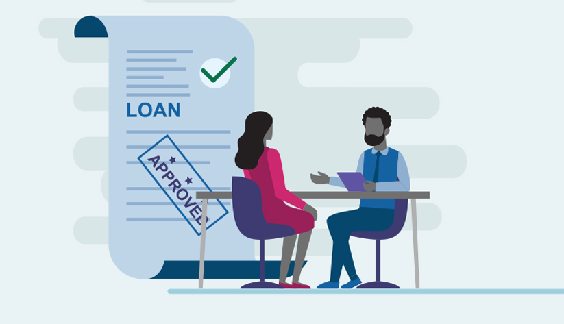 two people seated at table with loan with approval stamp in background